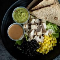 Southwest Chick Salad · Chicken, romaine, fire-roasted corn & black beans and guacamole with CE Spicy Ranch and tort...
