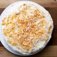 Coconut Cake (Slice) · Classic coconut layer cake topped with rich cream cheese icing and dusted with coconut flake...