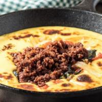 Queso Fundido (Choriqueso) · Grilled Mexican sausage with melted cheese. 1250 cal.