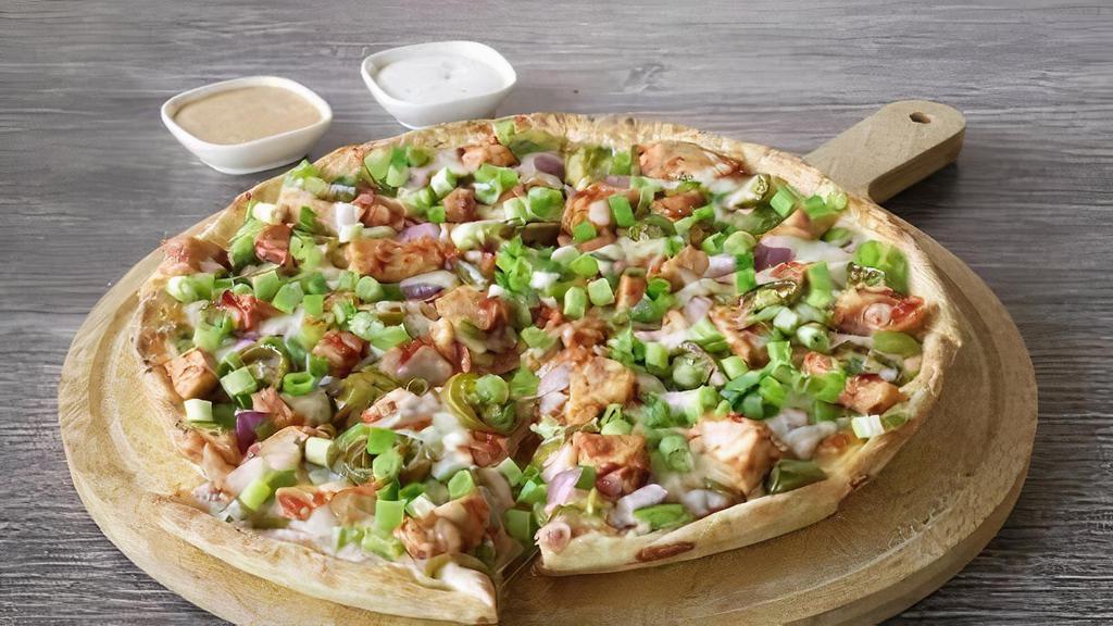 Vegan Manchurian Pizza · made with our signature Manchurian sauce, vegan cheese, crisp red onions, fresh bell peppers, spicy jalapeno, cauliflower bites, fresh cut; garlic, ginger, and green chilies, vegan garlic sauce, garnished with fresh green onions