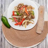 Lamb Tibs · Well seasoned and marinated tender lamb sautéed with vegetables and a blend of Ethiopian spi...