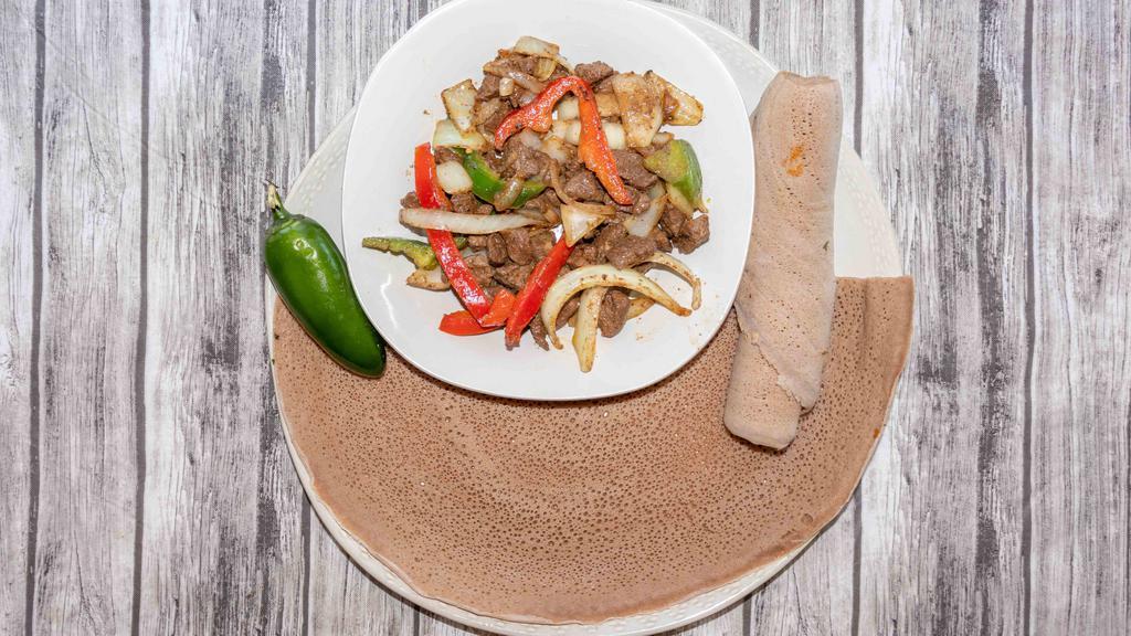 Lamb Tibs · Well seasoned and marinated tender lamb sautéed with vegetables and a blend of Ethiopian spices.