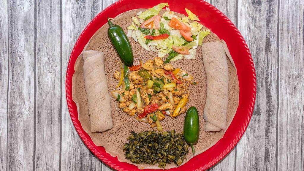 Chicken Tibs · Boneless chicken seasoned with Ethiopian spices sautéed with onion, tomato, and peppers topped with freshly squeezed lemon.