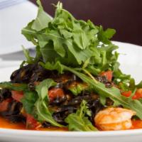 Linguini Neri Con Gamberi · Homemade Black Linguini tossed with shrimp in a mild tomato sauce garnished with baby arugul...