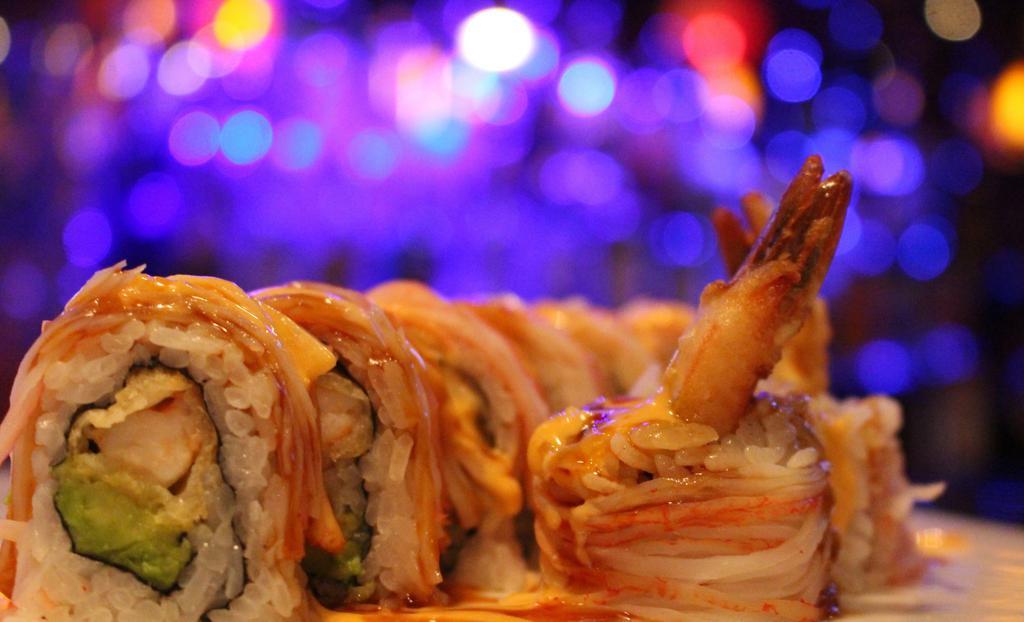Dynamite Roll · Shrimp tempura and avocado inside,  topped with crab stick, spicy mayo and eel sauce.