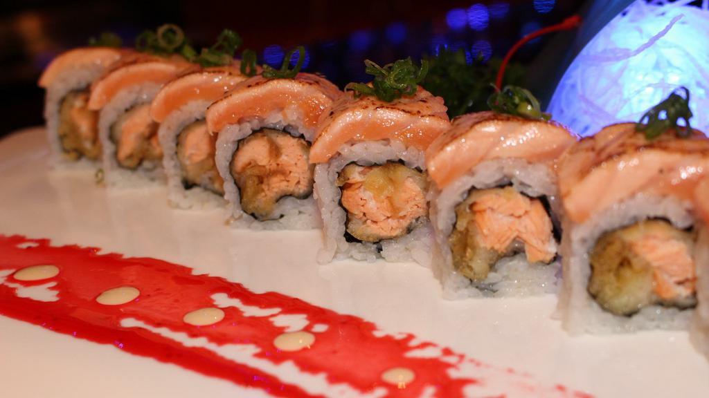 Cordova Roll · Salmon tempura and avocado, topped with seared salmon, garnished with green onions.