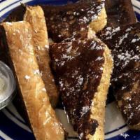 French Toast · Three slices of toast dipped in cinnamon vanilla batter with powdered sugar