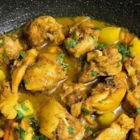 Curry Chicken · Jamaican curry chicken simmered with potatoes, carrots, scallions, and ginger & spices Serve...