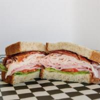 Regular Ass Club Sandwich · Traditional club sandwich with smoked turkey, hormel pit smoked ham, hardwood smoked bacon, ...