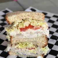 Old Fashioned Chicken Salad Sandwich · A blend of mayo, celery, onion, salt and pepper, topped with lettuce and tomato.