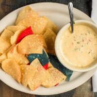 Espinaca Con Queso · Spinach and pepper jack cheese dip served with tri-color tortillas.