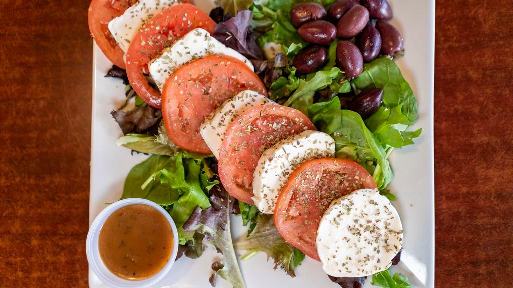 Caprese Salad · Fresh mozzarella cheese and tomatoes, garnished with Takis' special blend of Mediterranean spices, topped with extra virgin olive oil and basil dressing.