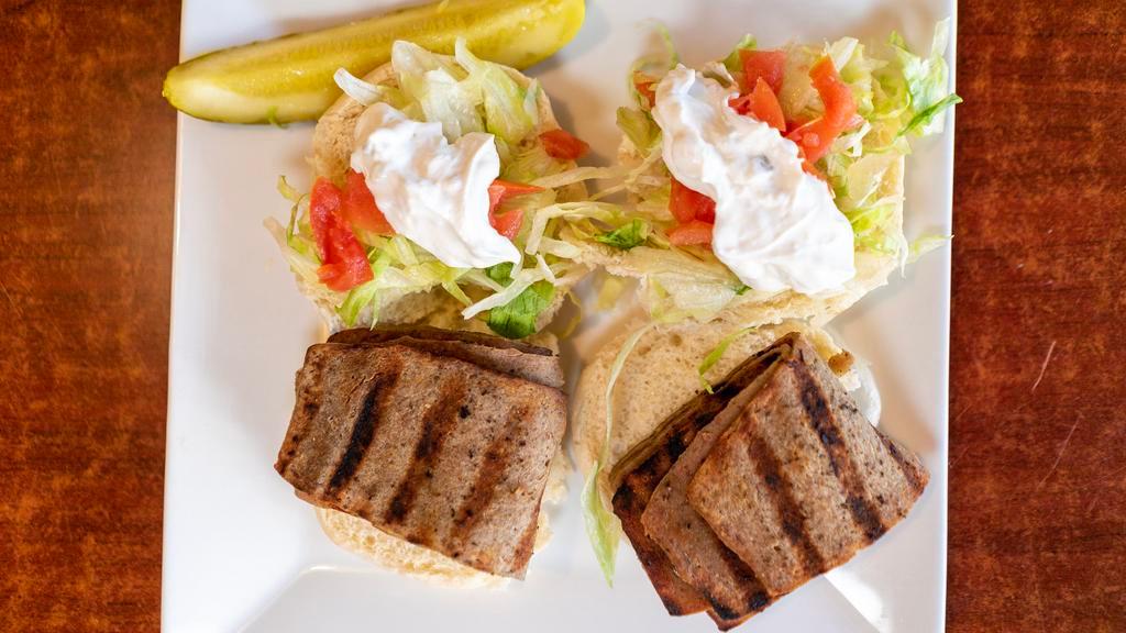Gyro Sandwich · Tender juicy slices of gyros meat in hot pita bread with tomatoes, lettuce, onions, tzatziki sauce and french fries.
