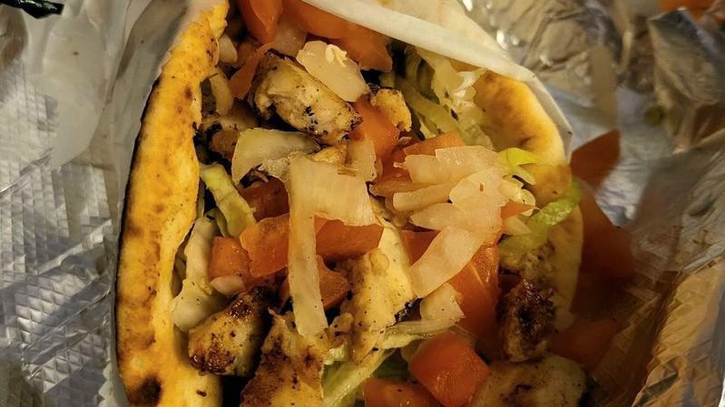 Souvlaki · Chunks of marinated chicken breast or pork tenderloin in hot pita bread with tomatoes, lettuce, onions, tzatziki sauce and french fries.