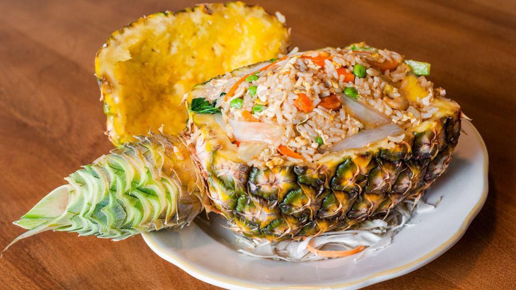 Pineapple Boat Fried Rice · Eggs, carrots, peas, raisins, onions, cashews and broccoli in fresh pineapple.