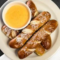 Soft Pretzel Sticks · Four served with our smoked Gouda beer cheese or Tossed in Cinnamon Sugar