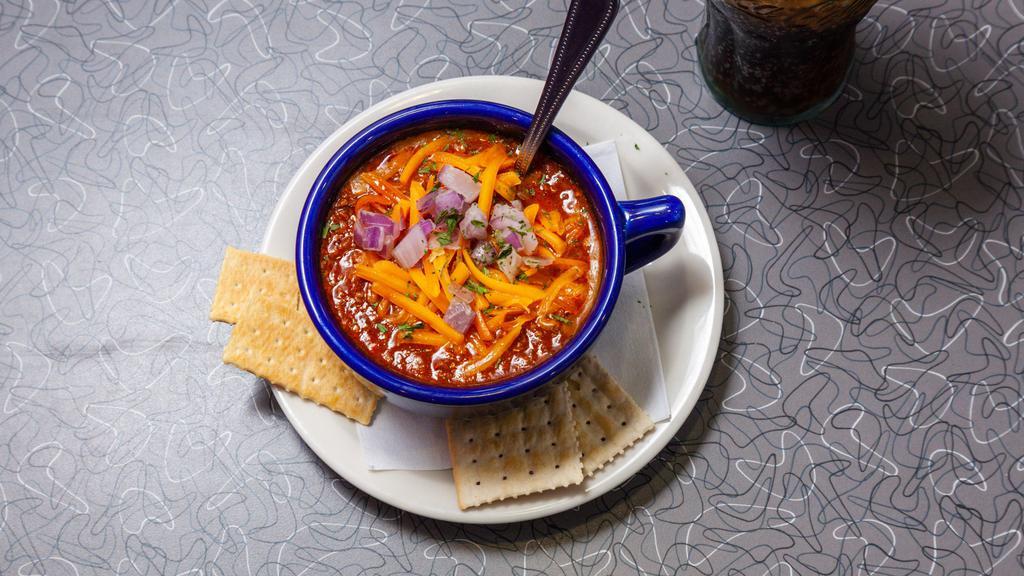 Purple Cow'S Famous Homemade Chili · Served with grated cheddar cheese and onions.