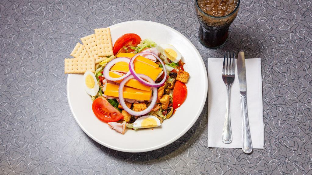 Classic Chef'S Salad · Mixed greens topped with smoked turkey, bacon, Swiss and cheddar cheeses, tomato, purple onions, hard-boiled egg, olive salad and croutons.