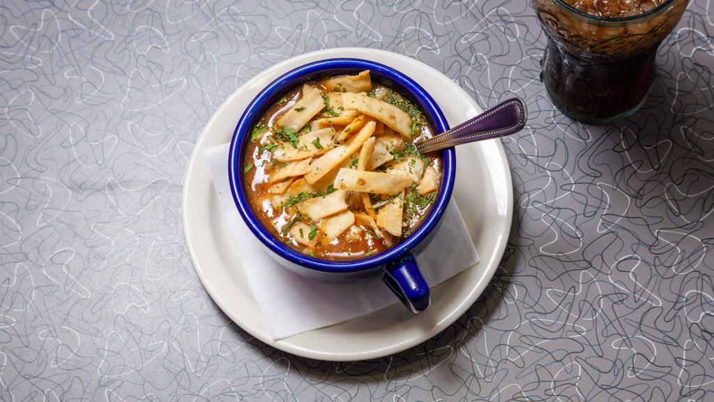 South Of The Border Soup · Made from chicken and beef stock with loads of all-white-meat chicken, peppers, tomatoes, onions and spices, topped with crispy tortilla strips and shredded Monterey Jack cheese.