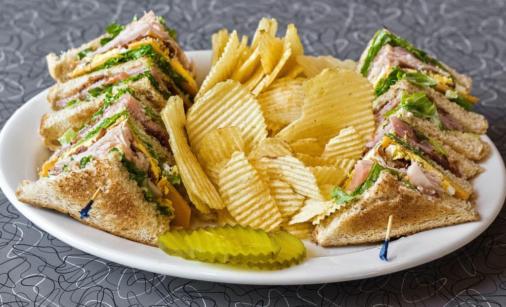 The Best Smoke Club Sandwich · Triple-decker with smoked turkey, bacon, ham, cheddar cheese, hard-boiled egg, tomato, lettuce and house mayonnaise, on wheat toast. Pickles on the side.