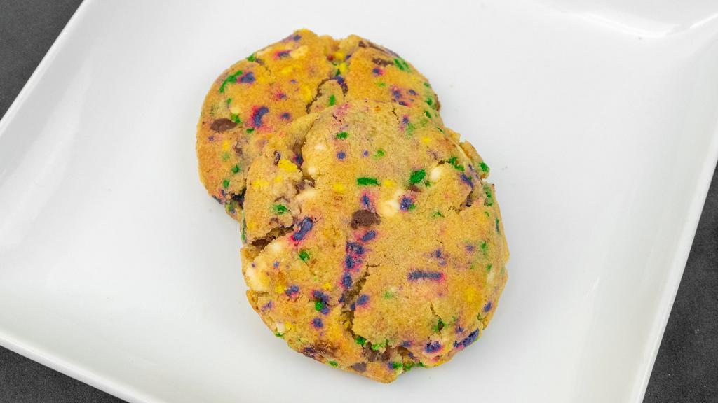 Fat Tuesday Deluxe Cookie · Our signature dough complimented with festive sprinkles and premium chocolate chunks and toffee bits. A party in your mouth.