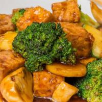 Tofu Asian Vegetables · Fresh broccoli, carrots, mushrooms, zucchini, cabbage and tofu cubes cooked in a light brown...