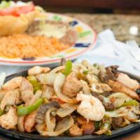 Across The Border Fajitas · Chicken, beef, and shrimp with a combination of grilled onions, green peppers, and tomatoes....