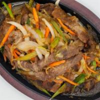 Sizzling Beef · New york strip sliced sauteed and stir-fried with carrots celery onions scallions and mushro...