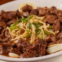 Yaki Mein · Served on top of linguine noodles with beef, green onions, bold egg, soy sauce.