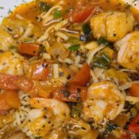 Seafood Linguine · Sautéed shrimp, scallops, sea bass, roasted garlic, leeks, cherry tomato sauce and pesto.
