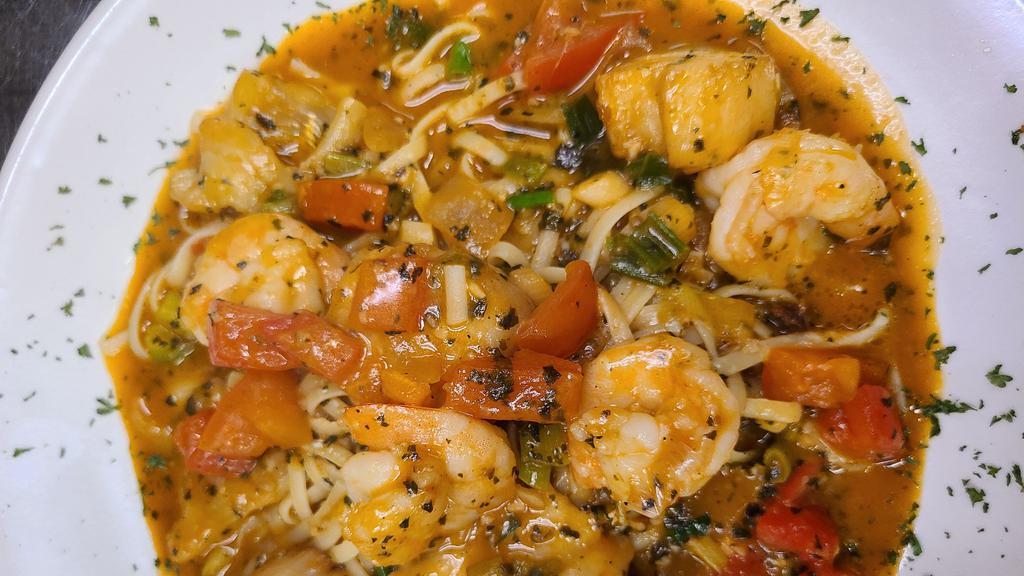 Seafood Linguine · Sautéed shrimp, scallops, sea bass, roasted garlic, leeks, cherry tomato sauce and pesto.