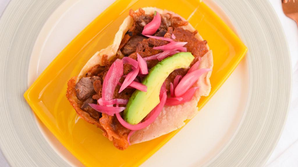Crunchy Cheese · Corn tortilla, sirloin on a bed a crunchy cheese, avocado, sweet-tangy pickled red onions.