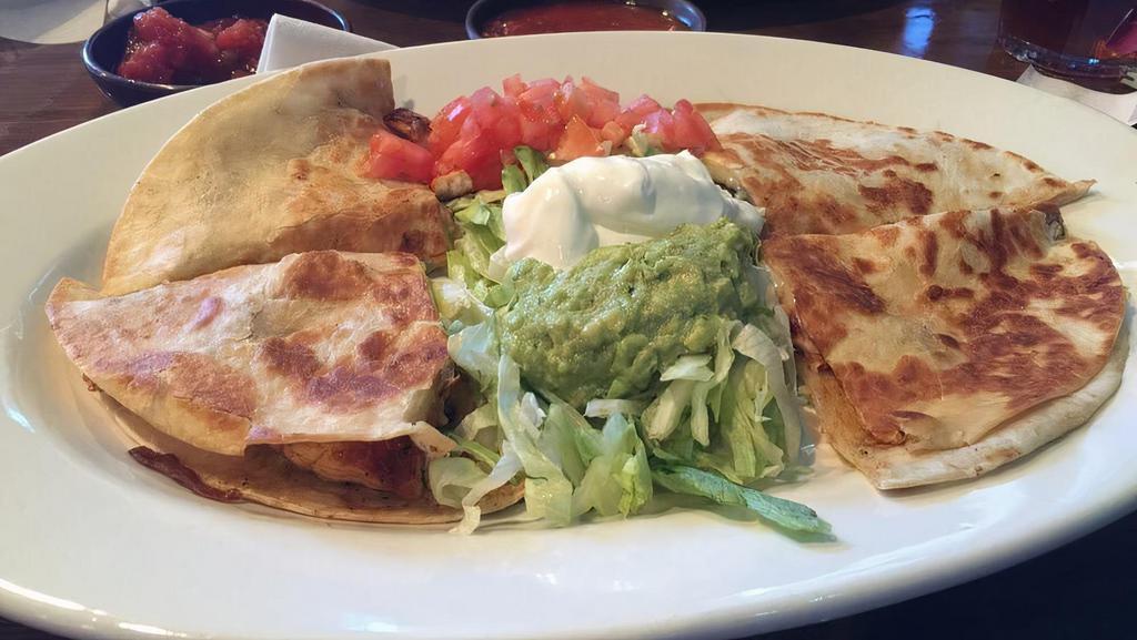 Fajita Quesadilla · Our big size flour tortilla stuffed with grilled beef or chicken and melted cheese served with lettuce, tomato, sour cream, and guacamole.
