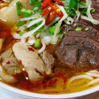 Bun Bo Hue-Large Only · Spicy beef soup with thick vermicelli noodles, beef shank, slices of Vietnamese pork bologna...