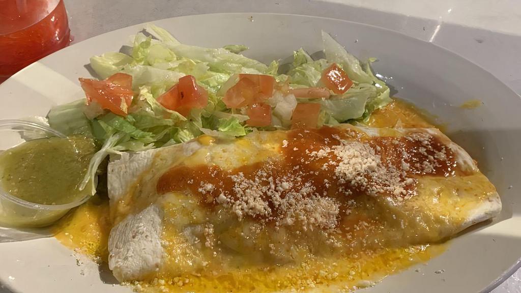 Seafood Enchilada · Seasoned chicken, beef, or beans wrapped in a flour tortilla, topped with melted Cheddar cheese, served with lettuce and tomato.