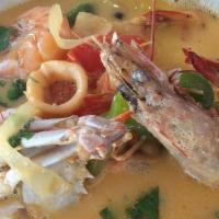 Seafood Soup · Milky and spicy soup made with crab, shrimp, fish, calamari, and vegetables. Served with a s...