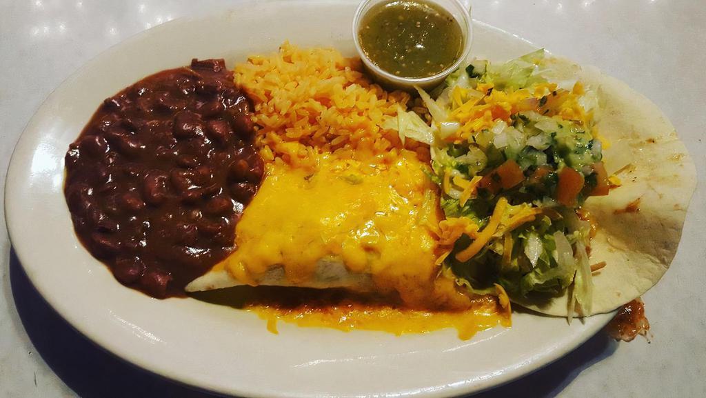 Mexican Combination With Chicken, Beef, And Seafood · A great assortment of Mexican food, including saffron, beans, lettuce, tomatoes, one enchilada, and one taco.