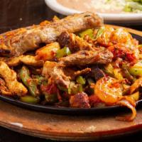 Fajitas · Tender strips of marinated chicken breast, steak or mixed. Cooked with sautéed onions bell p...