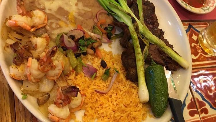 Combo Azteca · Skirt steak butterflied and flame broiled to your liking. four prawns laced with garlic and grilled, served with rice, beans cactus salad and tortillas.