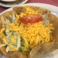 Taco Salad · Traditional taco salad is served on a crispy flour tortilla shell with choice of chicken or ...