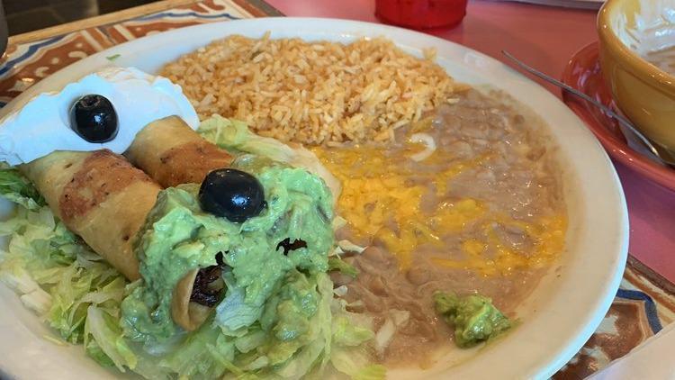 Chimichanga · Rolled, fried, and flour tortilla topped with lettuce, guacamole, and sour cream with choice chicken or ground beef. Served with rice beans.