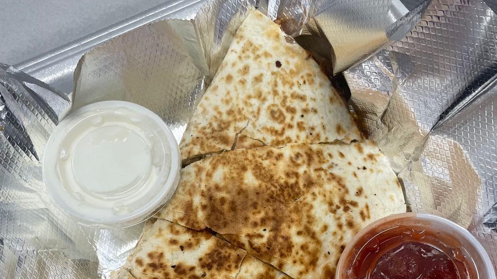 Quesadillas · A delicious treat with your choice of ground beef or chicken served with sour cream and salsa.