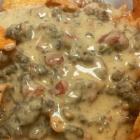 Rotel · A 'hood' classic! Queso cheese dip with ground beef. Served with Doritos chips.