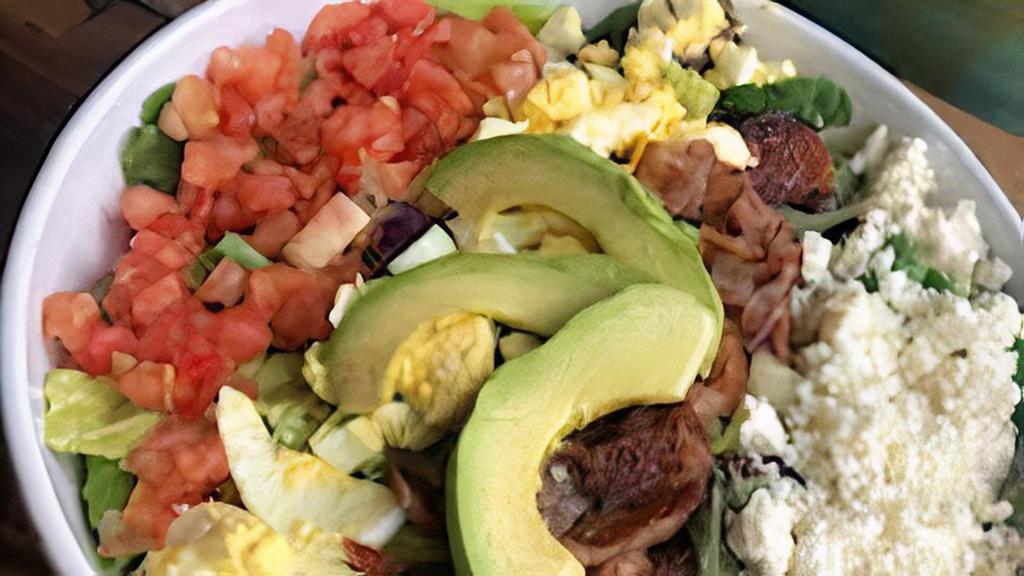 Cobb Salad With Grilled Chicken · Fresh spring mix with sliced grilled chicken crumbled feta cheese, hickory smoked bacon, hard boiled egg, fresh avocados and tomatoes.