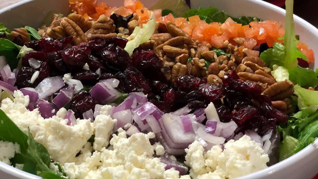 Cascade Salad · Gluten-free. Spring mix with red onions, feta cheese, tomatoes, craisins, and pecans with our homemade raspberry vinaigrette dressing.