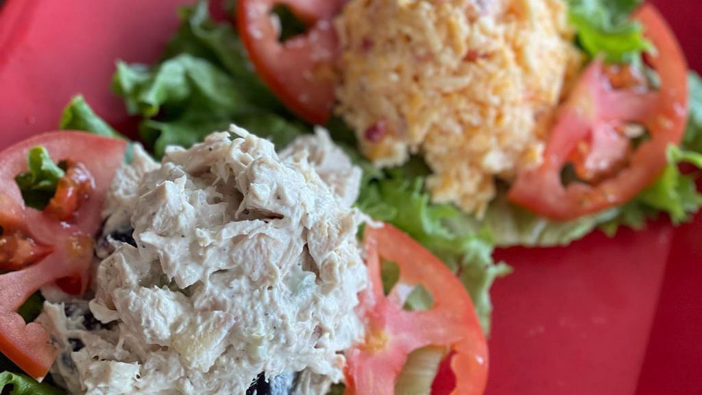 Salad Sampler Pick 2 · Gluten-free. Your choice of two salads: chicken, ham, pimento cheese, jalapeño pimento cheese, egg, and olive, albacore tuna, pasta or potato. Served on a bed of lettuce with sliced tomatoes.