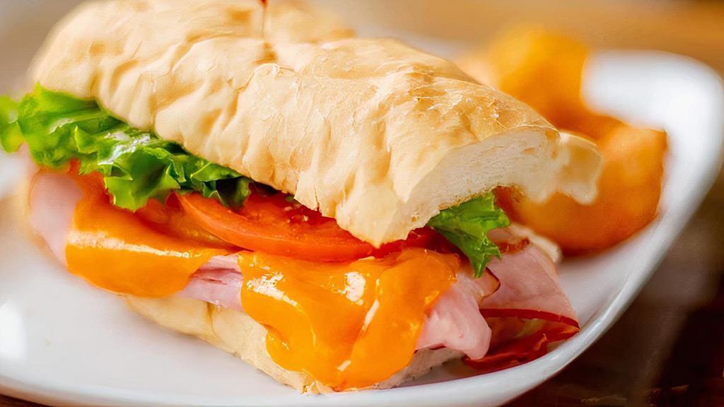Holiday Hot Ham & Cheese · Our famous spiral sliced ham, cheddar cheese, lettuce, and tomato with our spicy honey mustard and mayo on a hoagie.