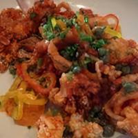 Sweet & Spicy Calamari · Lightly fried calamari, tossed in a spicy sweet sofrito sauce. Served over a black olive aio...