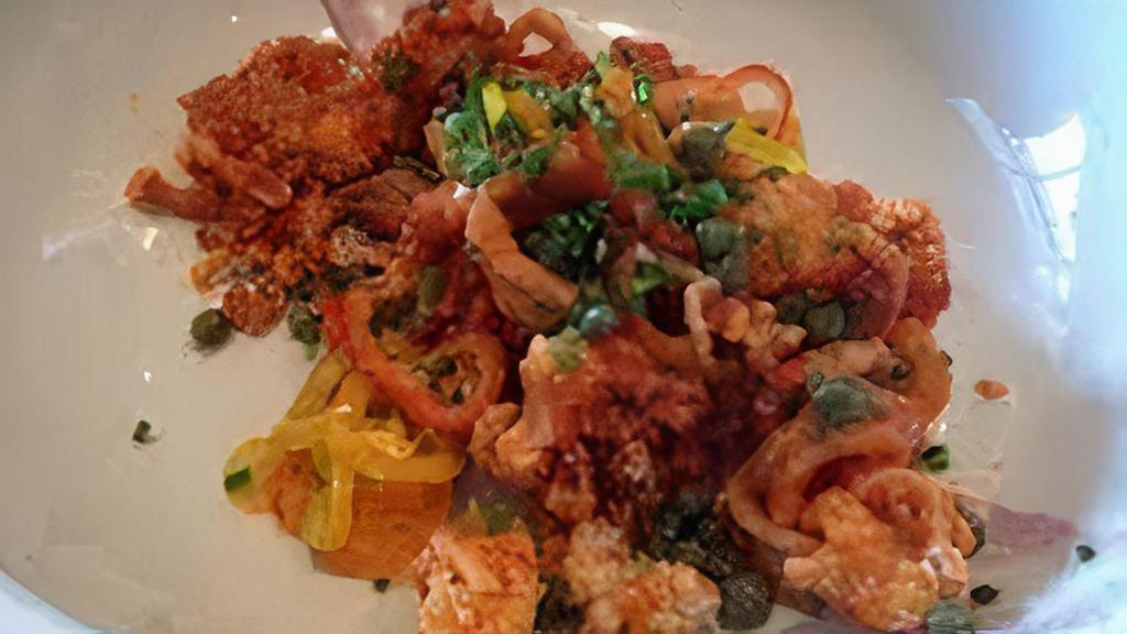 Sweet & Spicy Calamari · Lightly fried calamari, tossed in a spicy sweet sofrito sauce. Served over a black olive aioli, with a mix of capers and sweet Italian peppers