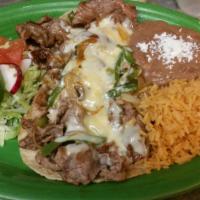 Quesado Gratinado · Two flour tortillas with grilled onions and peppers with chicken or steak, topped with melte...